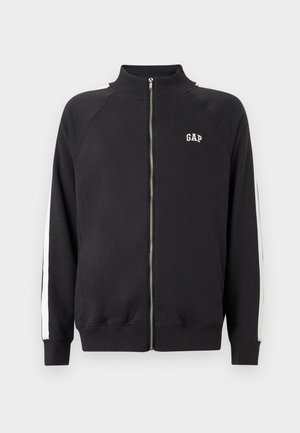 Black zip-up sweatshirt with high collar, white side stripes, and GAP logo on the chest. Made from textured cotton material.