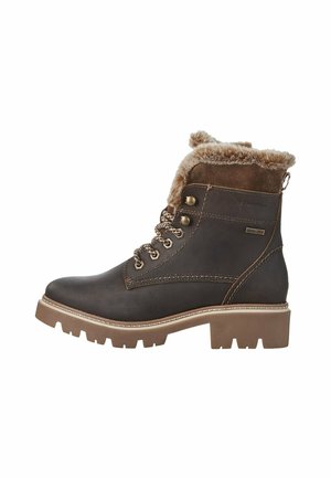 Brun læder ankelstøvle med faux fur krave, snørebånd design, rund tå og tyk, robust sål. Har metalhardware og kontrasterende syninger.