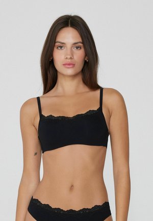 Black bralette with lace trim, adjustable straps, and a smooth fabric. Features a simple, classic design without padding or underwire.