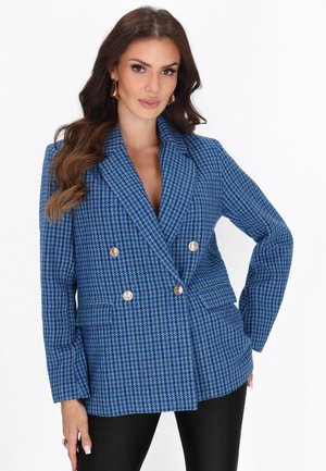 Modrý a černý blazer s dvojitým zapínáním v kostkovaném vzoru houndstooth, se zlatými knoflíky, klopami a dvěma předními kapsami. Texturovaná tkanina.