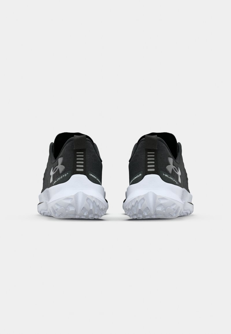 Schwarze Sportschuhe verfügen über ein strukturiertes Obermaterial, ein großes Markenlogo, eine Zuglasche und eine weiße Gummisohle mit Traktionsmustern.
