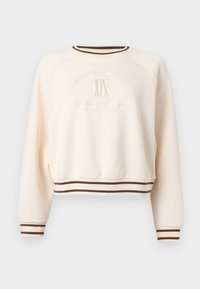 Μπεζ φούτερ με μακριά μανίκια, καφέ ριγέ μανσέτες και στρίφωμα, με ανάγλυφο το λογότυπο "Giorgio Sports Club" και "A|X" στο μπροστινό μέρος.