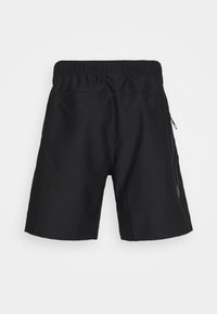 Czarne sportowe szorty z elastycznym pasem i boczną kieszenią na zamek, pokazane od tyłu na jasnym, jednolitym tle.