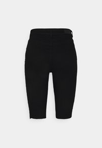 Shorts negros de talle alto y longitud hasta la rodilla con un dobladillo deshilachado y costuras mínimas visibles sobre un fondo blanco liso.