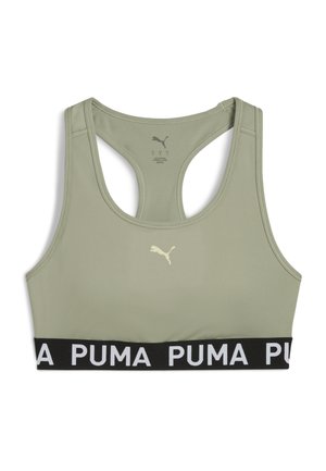 Sportski grudnjak u svijetloj maslinasto zelenoj boji s crnim elastičnim trakama na kojima se nalazi bijeli logotip. Ima oblik racerback, glatku teksturu i minimalno brendiranje.