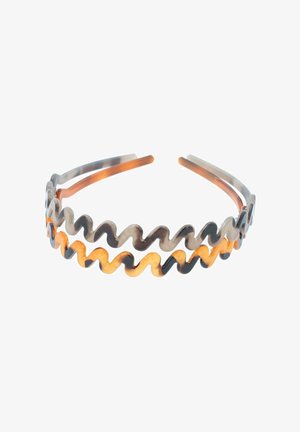 Golvend haarband met afwisselende kleuren bruin en oranje. Gemaakt van flexibel materiaal met twee verlengde armen om het in het haar te bevestigen.