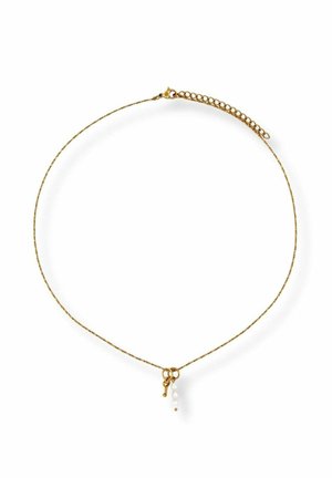 Delicate gold chain necklace with small key charm and three tiny white pearls hanging near the clasp.