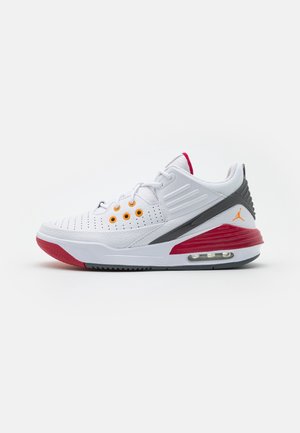 Chaussure de basketball blanche, rouge et grise avec semelle à coussin d'air, œillets orange et logo Jumpman, montrée de profil sur fond blanc.