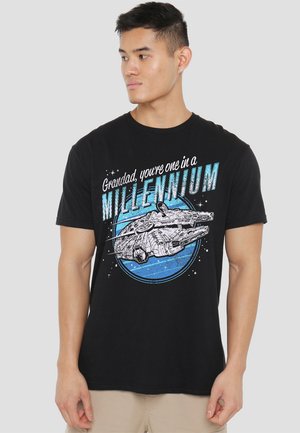 Black cotton t-shirt featuring a graphic of a spaceship and the text "Grandad, you're one in a MILLENNIUM" in blue and white.