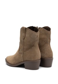 Brown suede ankle boots with a curved top, low stacked heel, and side seams, showcasing a smooth texture and classic design.