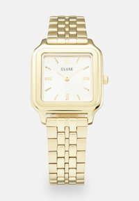 Montre carrée dorée avec un bracelet en métal poli, un cadran blanc, des index horaires dorés et le nom de la marque "CLUSE" centré sous 12 heures.