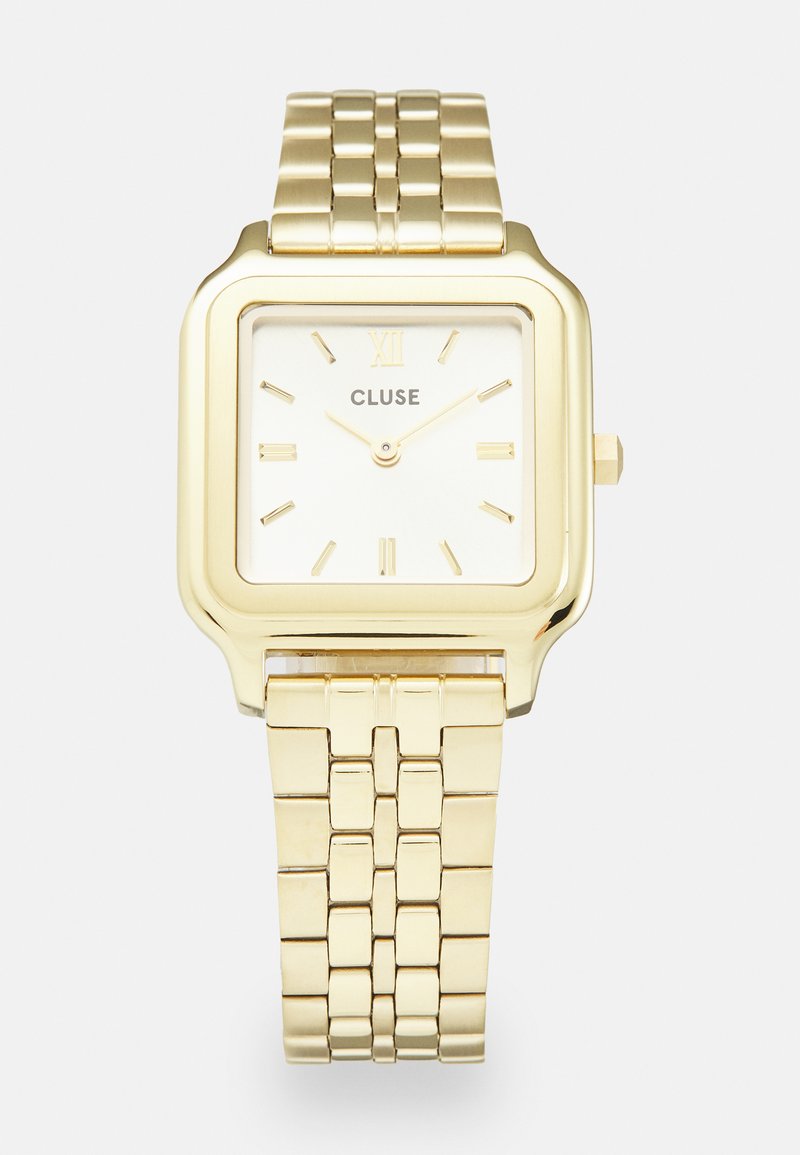 Montre carrée dorée avec un bracelet en métal poli, un cadran blanc, des index horaires dorés et le nom de la marque "CLUSE" centré sous 12 heures.