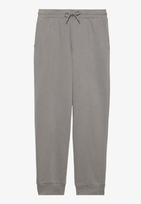 Pantalon de survêtement gris en tissu doux, avec une taille élastique dotée d'un cordon de serrage, des poches latérales et des poignets élastiques aux chevilles.