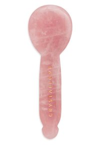 Rozenkwarts gezichtsapparaat met een glad, rond bovenkant en een platte handgreep, met een gouden reliëftekst "CRYSTALLOVE".
