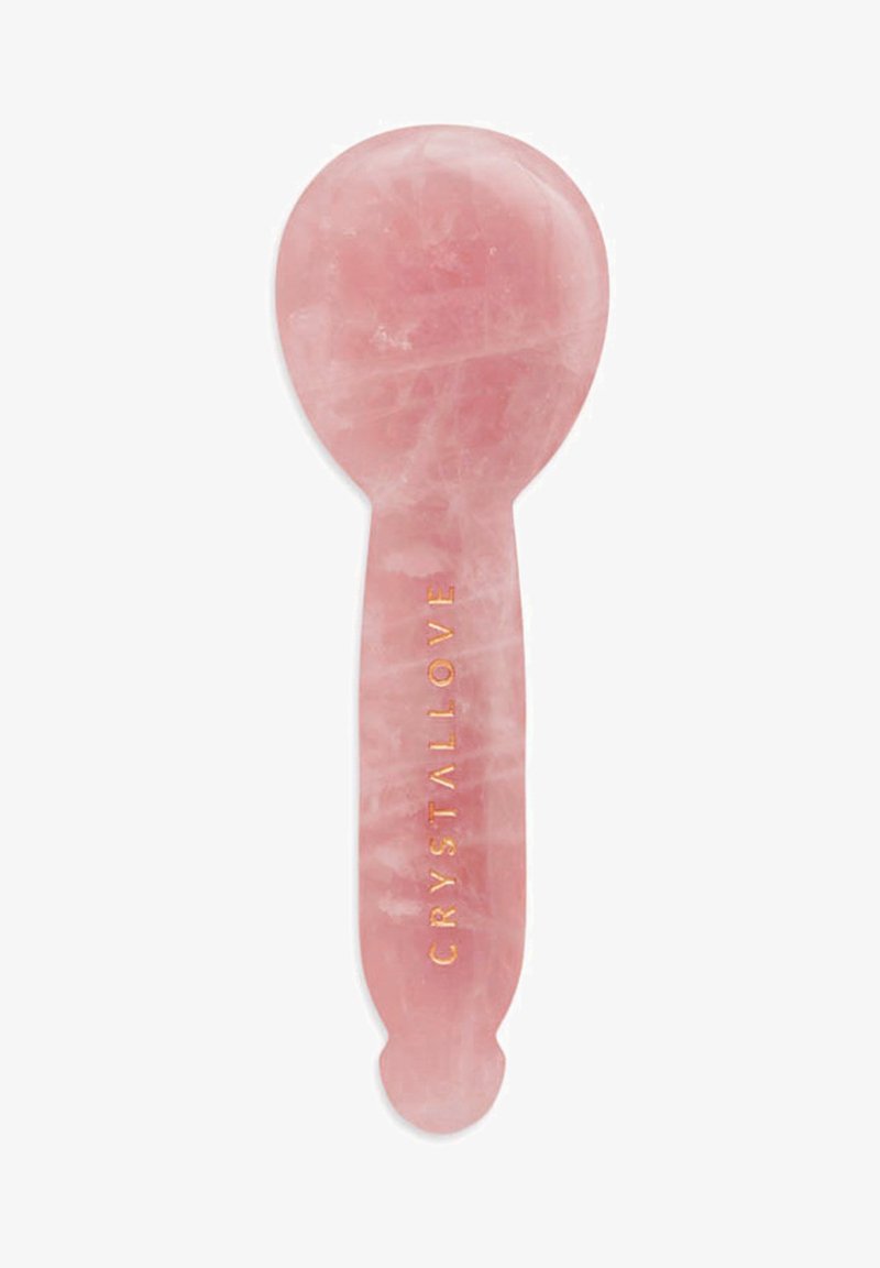 Rozenkwarts gezichtsapparaat met een glad, rond bovenkant en een platte handgreep, met een gouden reliëftekst "CRYSTALLOVE".