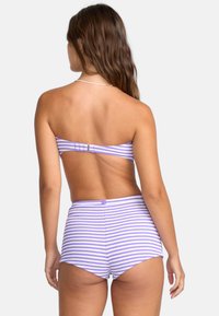 Striped purple and white bikini top with a back clasp, paired with high-waisted shorts featuring the same pattern and texture.