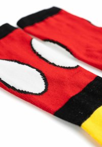 Calze rosse con due grandi forme ovali bianche contornate di nero. Cuffia nera e un accento giallo sulla punta. Morbido tessuto lavorato a maglia.