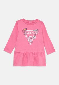 Robe rose à manches longues avec un ourlet froncé, présentant un graphique central d'un ours et des icônes, fabriquée en matériau doux.