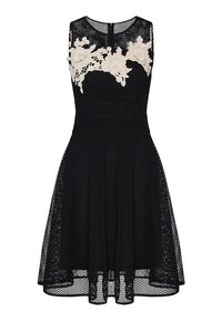 Robes sans manches en résille noire avec une jupe évasée et des appliqués en dentelle florale beige sur la poitrine et les épaules, dotée d'une fermeture éclair dans le dos.