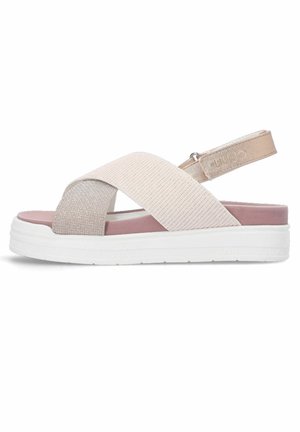 Sandales légères avec des sangles élastiques entrecroisées dans des tons beige et rose, dotées d'une semelle plateforme blanche et d'une bride de cheville réglable.