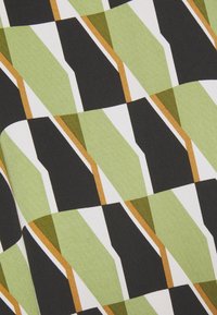 Motif géométrique avec des formes superposées en vert olive, noir, blanc et jaune moutarde, formant un design abstrait répétitif sur tissu.