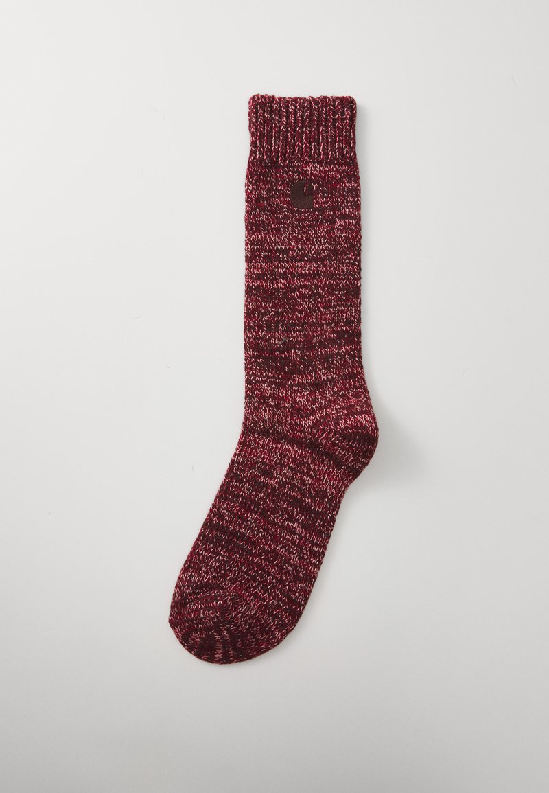Calcetín de punto en diseño burdeos y con manchas rojas, con puño acanalado, longitud a media pantorrilla y un pequeño detalle de logo en el lateral.
