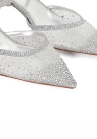 Silver pointed-toe heels with transparent mesh, embellished with clear rhinestones. Features a decorative silver trim along the edge for accent.
