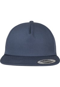 Navy blue snapback cap made of canvas with a flat visor, featuring a round logo tag on the front. Smooth texture, structured design.