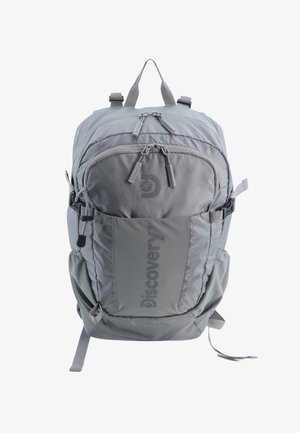 Gray backpack with a textured finish, multiple zippered compartments, adjustable straps, and a side pocket featuring a logo.