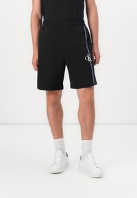 Calvin Klein - UNISEX - Šorti - black Miniatūras attēls 1