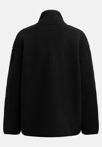 Black fleece pullover with a high collar, loose fit, and textured surface. Features dropped shoulders and minimalistic design for comfort.