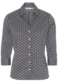Chemise à manches longues noir et blanc avec un motif floral géométrique, boutonnée à l'avant et avec un col. Fabriquée en tissu tissé avec une texture lisse.