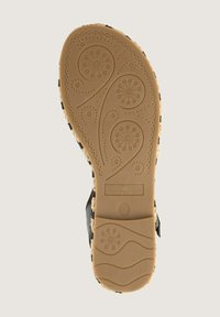 Lightweight sandal sole with a patterned rubber bottom. Tan color with floral engravings. Features a black strap with adjustable buckle.