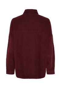Burgundy kordflorskjorta med krage, långa ärmar, en något oversized passform och knäppta manschetter, med strukturerad tyg.