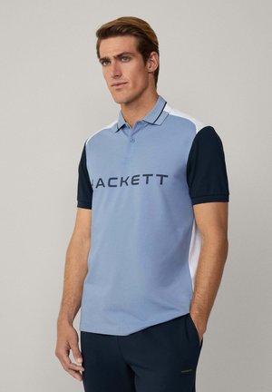 Polo shirt in light blue with dark blue sleeves and white accents. Features a collar, three buttons, and "HACKETT" printed on the front.