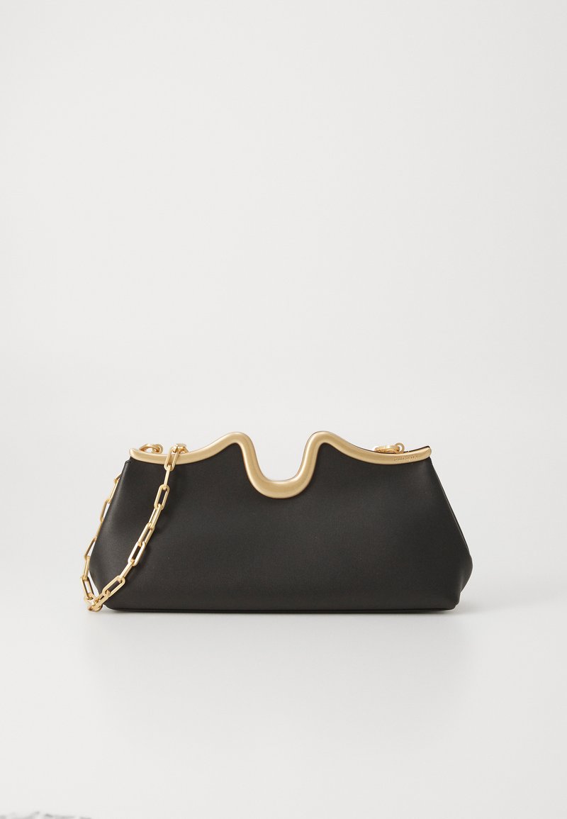 Black handbag with a wavy gold top edge and chain strap. Smooth texture and structured shape, designed for a modern aesthetic.
