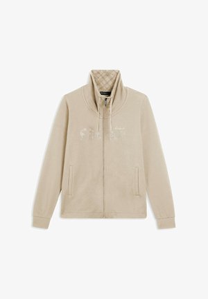 Veste zippée beige avec un col haut. "VENDREDI" en strass brillants sur le devant. Tissu doux avec une texture lisse et poches latérales.