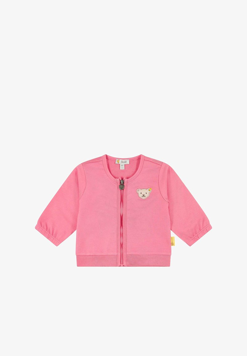 Růžový bavlněný kardigan s dlouhými rukávy, předním zipem a nášivkou medvěda na hrudi. Měkká struktura a neformální design.