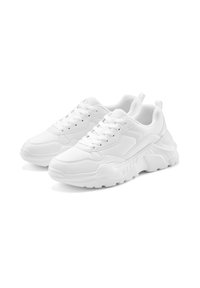 White sneakers with a chunky design, made of smooth synthetic material, featuring thick soles, lace-up front, and padded collar.