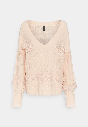 Pull en tricot rose clair avec un col en V, un design côtelé et des motifs en dentelle aux manches et au corps pour ajouter texture et détails.