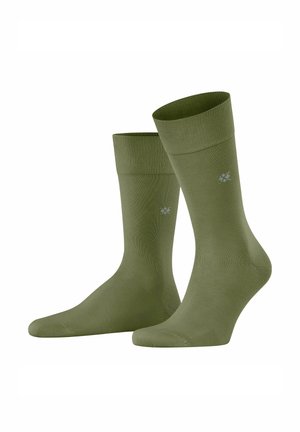 Paar olivgrüne Socken in mittlerer Wadenlänge mit einem kleinen, dezenten Logo in der Nähe des Knöchels auf weißem Hintergrund.