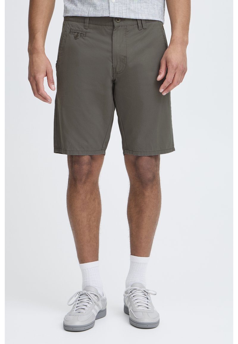 Olive green shorts made of lightweight fabric, featuring a button closure, front pockets, and a relaxed fit. Simple hemmed edges.