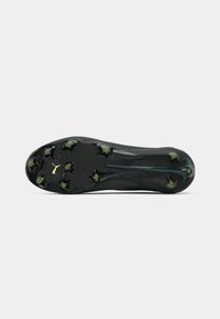 Semelle de crampons de foot noire avec une surface texturée, huit crampons coniques et un logo en accent vert. Forme ergonomique pour des performances optimales.
