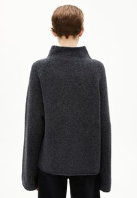 Gray wool blend sweater with a high collar, dropped shoulders, and a relaxed fit, featuring a textured surface and minimal seams.