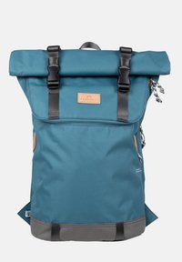 Turkusowy plecak z odchylaną górą, czarne paski i elementy metalowe, skórzana etykieta, szary spód oraz boczne kieszenie dla dodatkowej funkcjonalności.