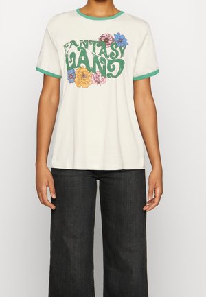 White t-shirt with green ringer collar and sleeves. Features “FANTASY LAND” graphic in green, pink, and blue floral designs. Soft fabric.