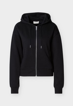 Black zip-up hoodie made from soft fabric. Features a drawstring hood, ribbed cuffs, and a small logo on the left side. Cropped design.
