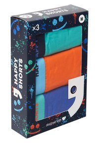 Drie shorts in een doos, in de kleuren turquoise, oranje en marineblauw. De doos toont speelse graphics en een label met de tekst "Happy Shorts".