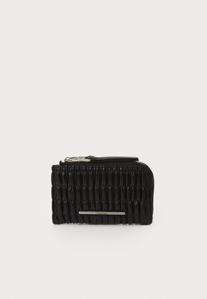 Black zippered wallet featuring a textured surface with a series of vertical ridges and a silver-tone hardware accent on the front.