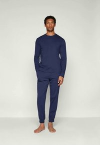 Navy blue long-sleeve top and matching pants made of soft fabric; fitted design with ribbed cuffs and ankle hems. No patterns or accents.